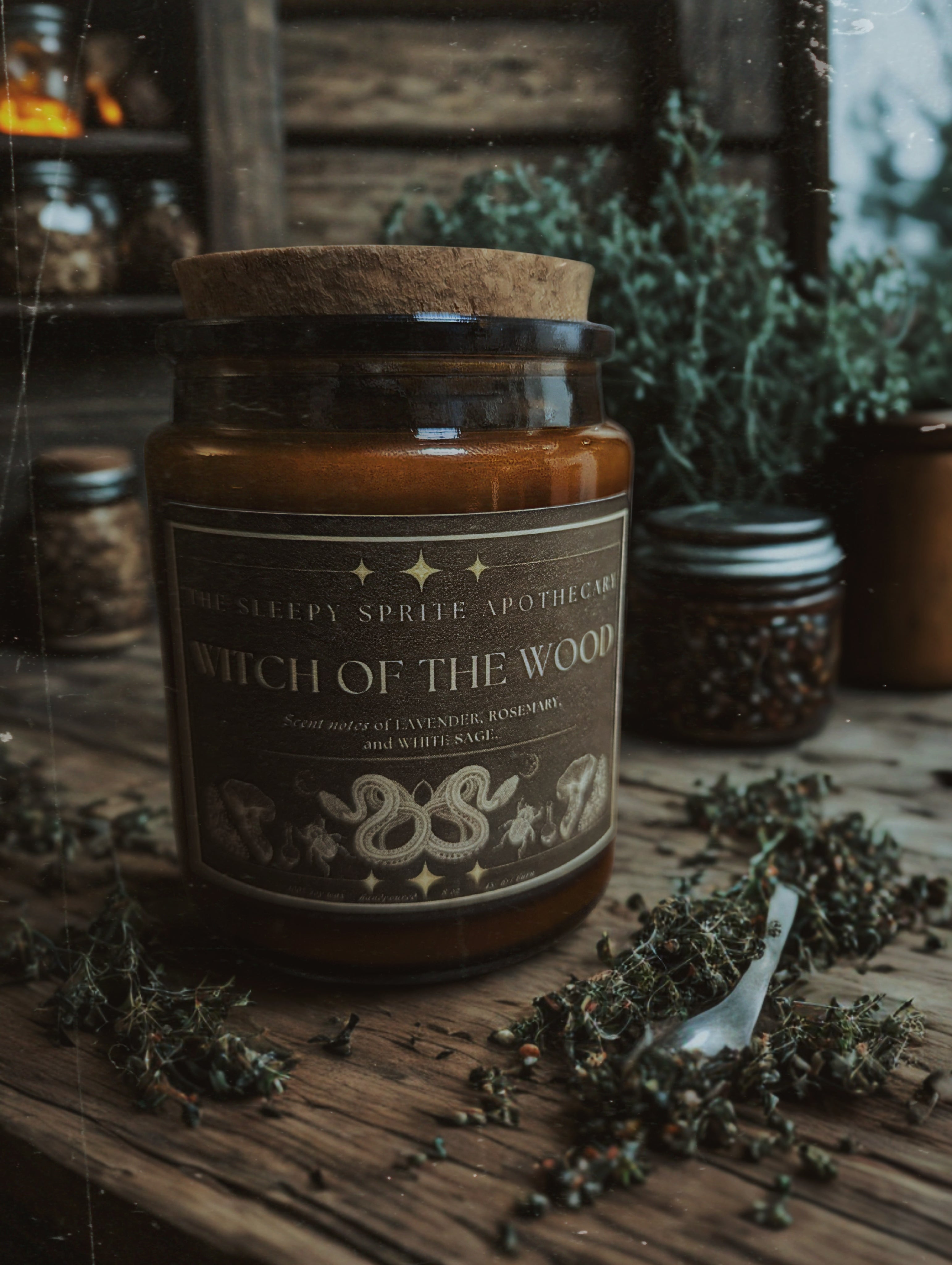 Jar labeled 'Witch of the Wood' on a wooden surface with herbs. Witchy dark cottagecore aesthetic.